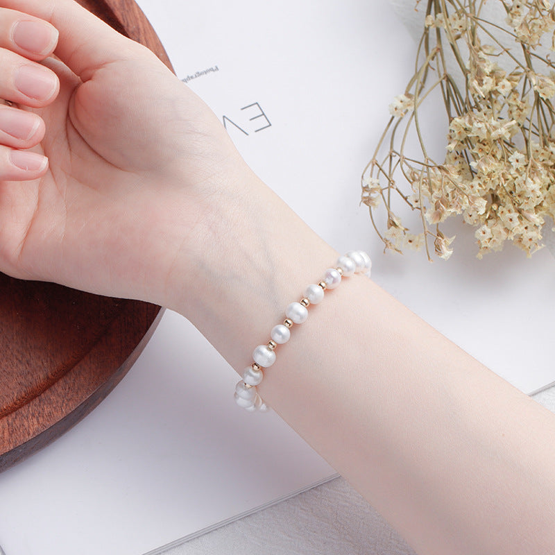 Fortune's Favor Sterling Silver Freshwater Pearl Bracelet with Delicate Stars and Moon Design