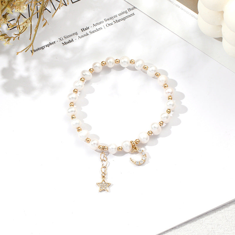 Fortune's Favor Sterling Silver Freshwater Pearl Bracelet with Delicate Stars and Moon Design