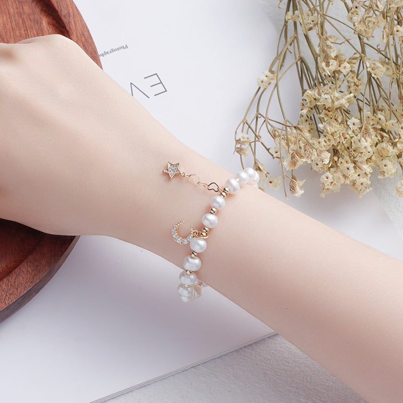 Fortune's Favor Sterling Silver Freshwater Pearl Bracelet with Delicate Stars and Moon Design