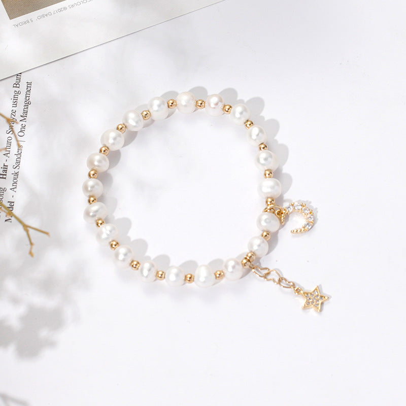 Fortune's Favor Sterling Silver Freshwater Pearl Bracelet with Delicate Stars and Moon Design