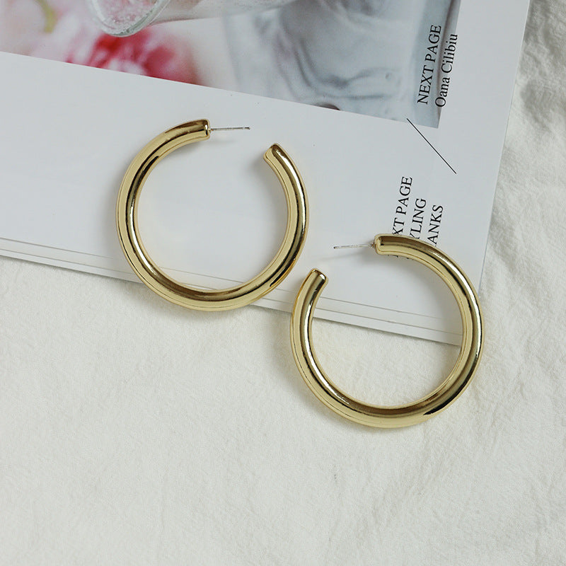 Golden Geometric C-Shaped Earrings with Global Appeal