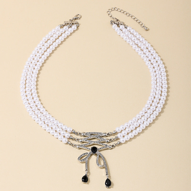 Extravagant Bow Tassel Pendant Pearl Necklace with Retro Flair