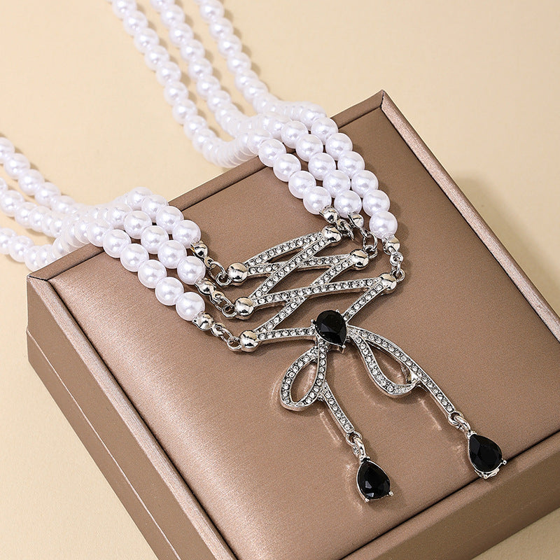 Extravagant Bow Tassel Pendant Pearl Necklace with Retro Flair