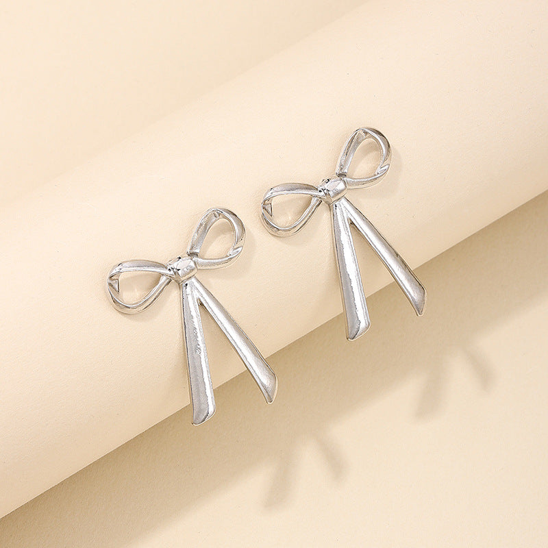 Exaggerated Metal Ribbon Knot Earrings with a Touch of Vienna Glam