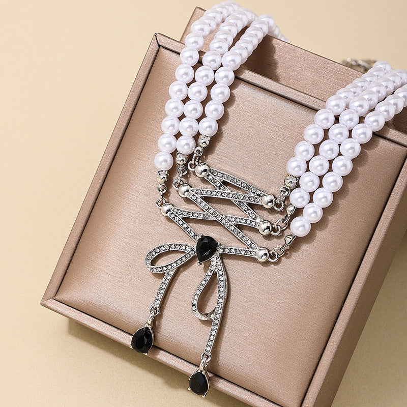 Extravagant Bow Tassel Pendant Pearl Necklace with Retro Flair